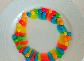 arco iris de confites en un plato con agua
